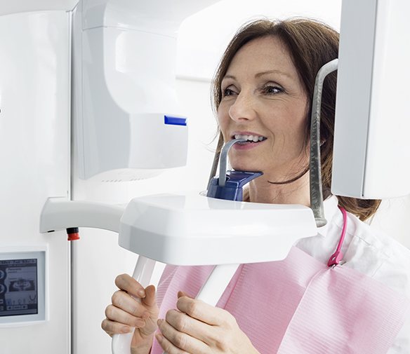 Woman receiving 3 D C T cone beam x-ray scans